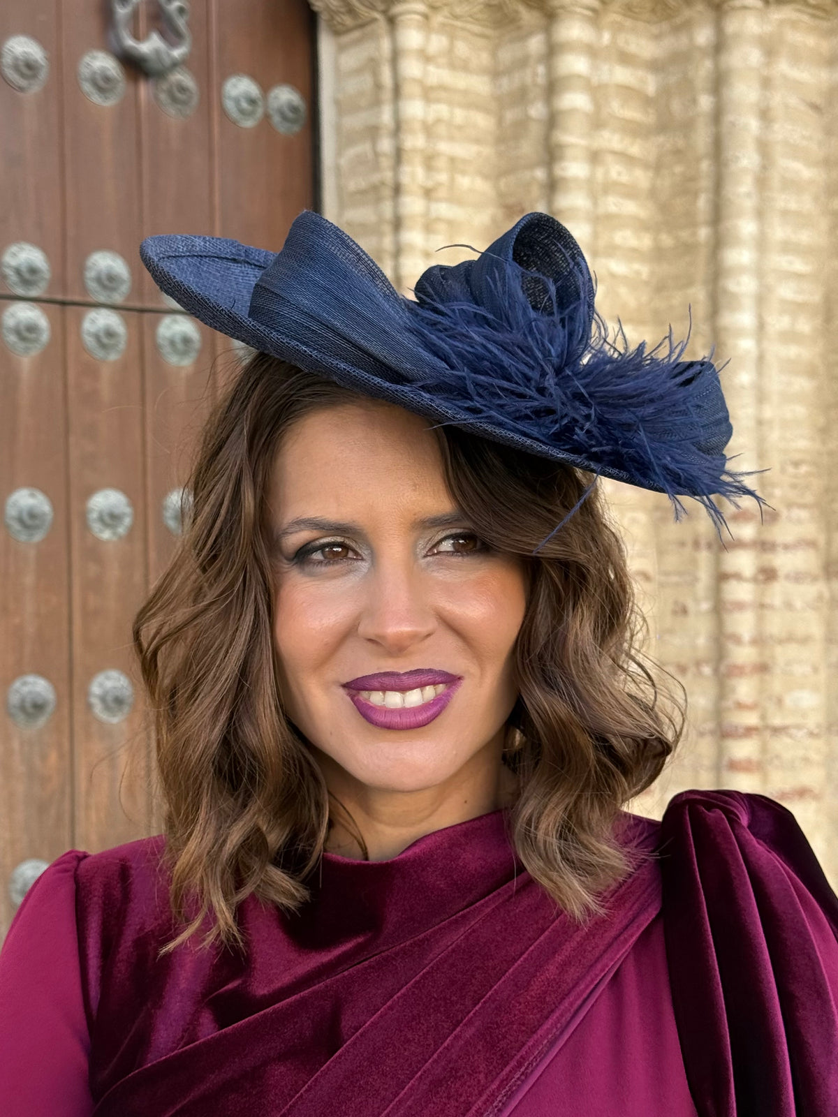 Tocado azul marino con lazada y plumas