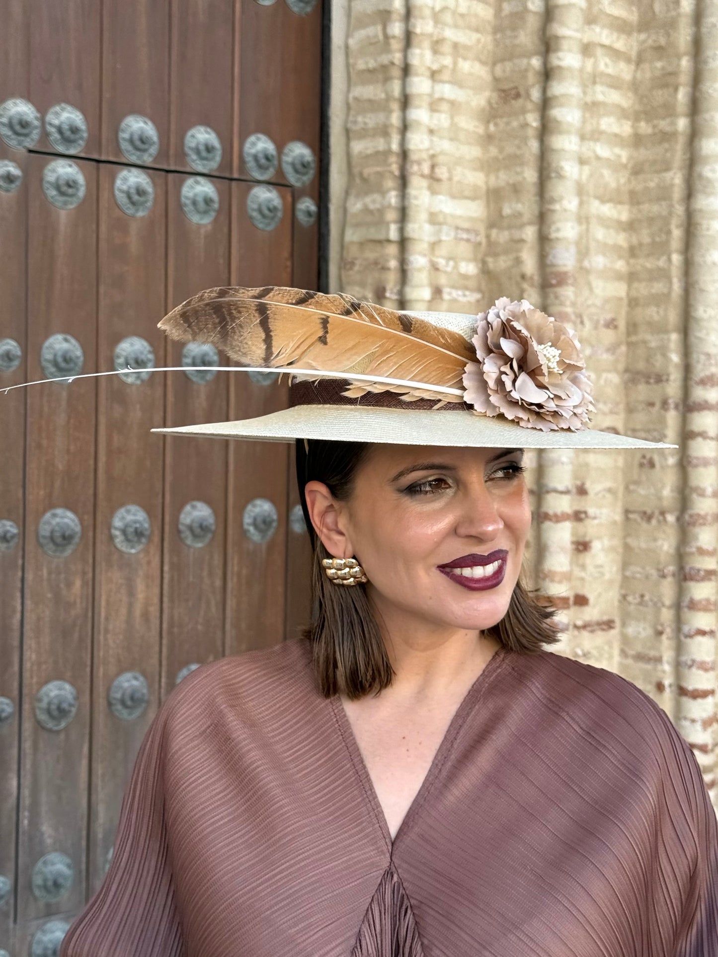 Pamela de invitada con flores y plumas