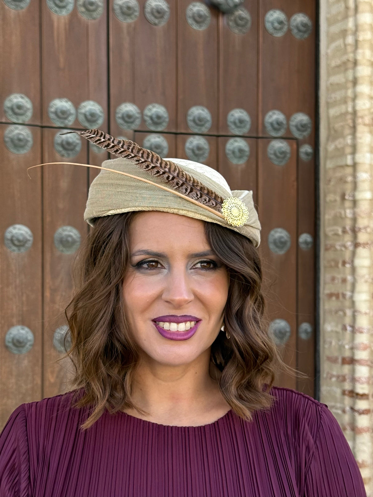 Tocado Inés tipo casquete beige con pluma y adorno dorado